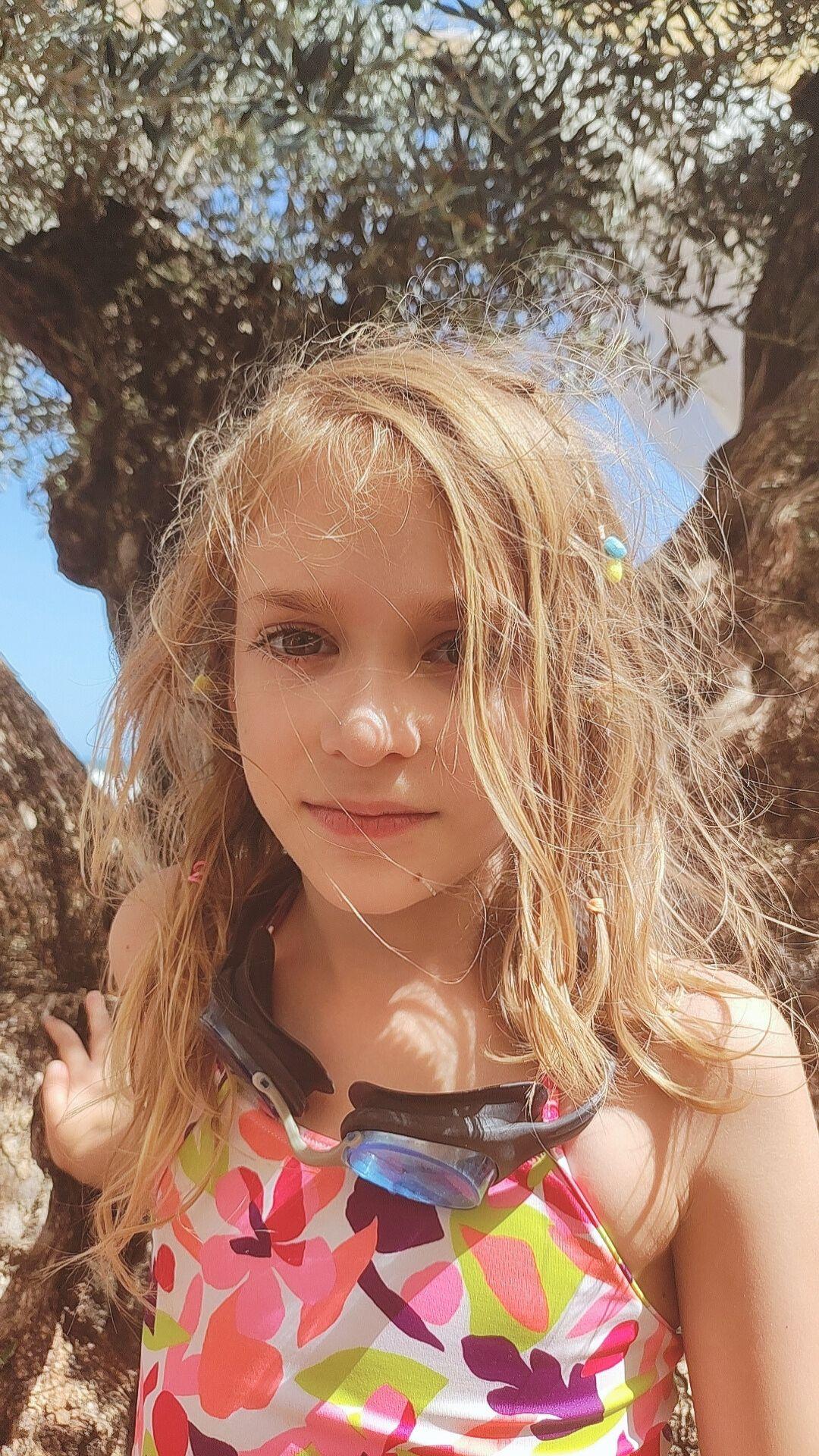 Her daughter under an olive tree.